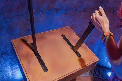 Person pulling a lever on a metal box.