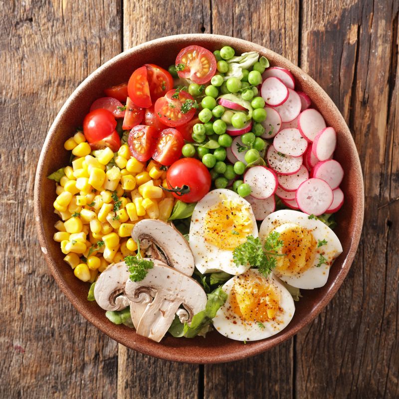 Top View of Healthy Buddha Bowl with Egg Radish Tomato and Mushroom