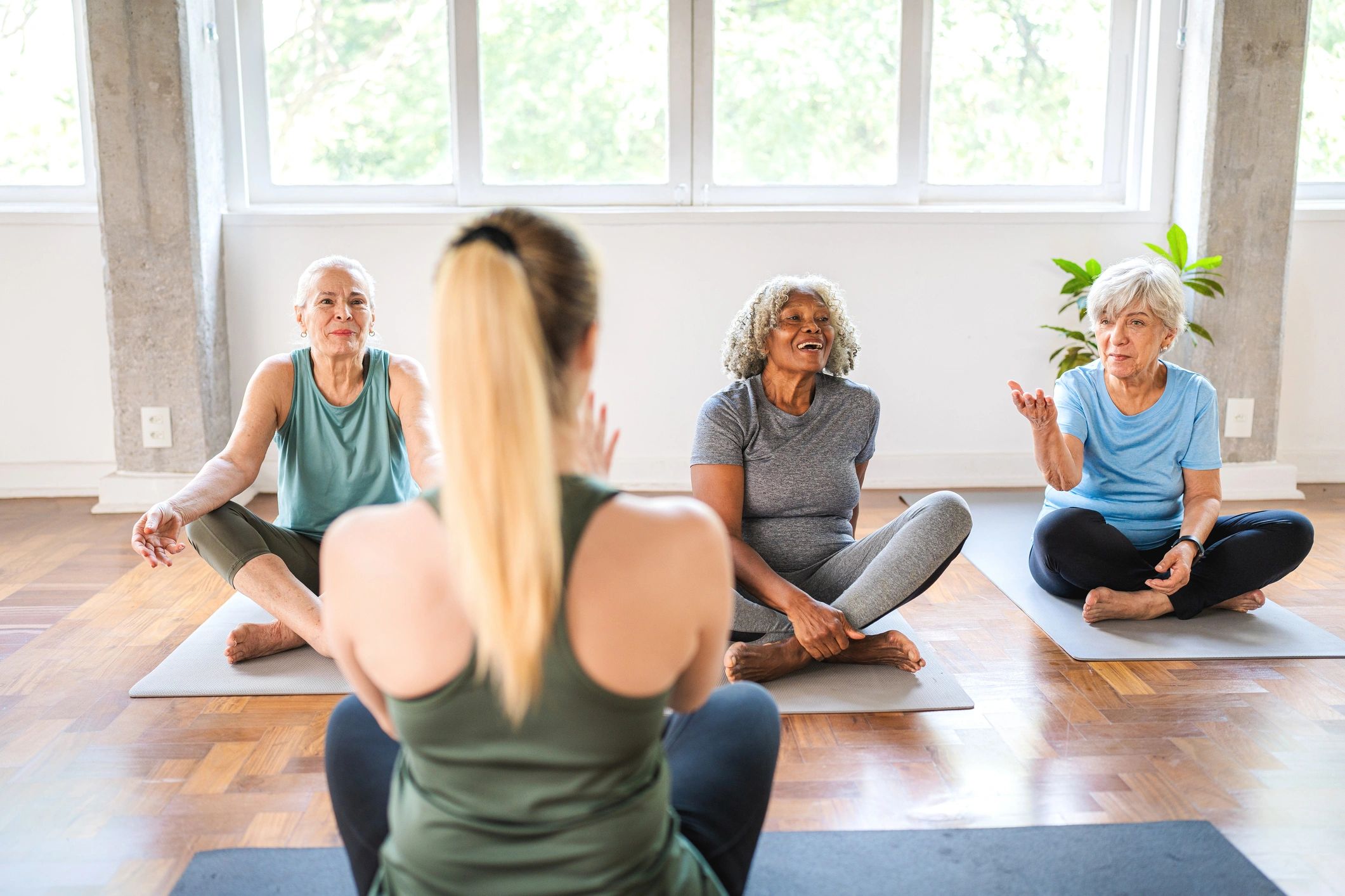 Older women doing yoga with instructor.