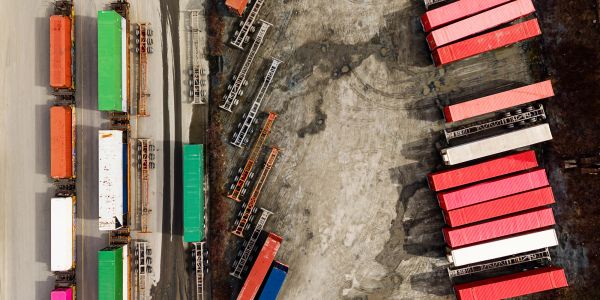 Aerial view of colorful cargo containers and trailers in a yard.
