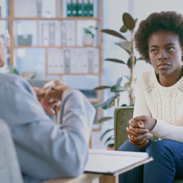 Woman attentively listens during a counseling session with a therapist.