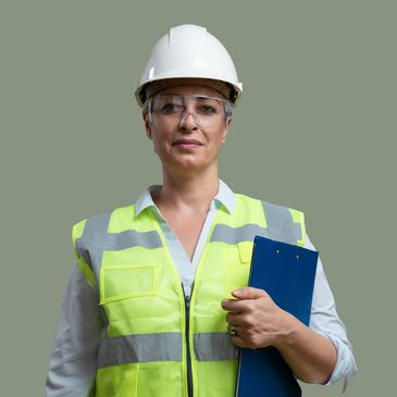 Confident female engineer in safety gear holding a clipboard.