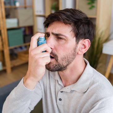 Man using an asthma inhaler.