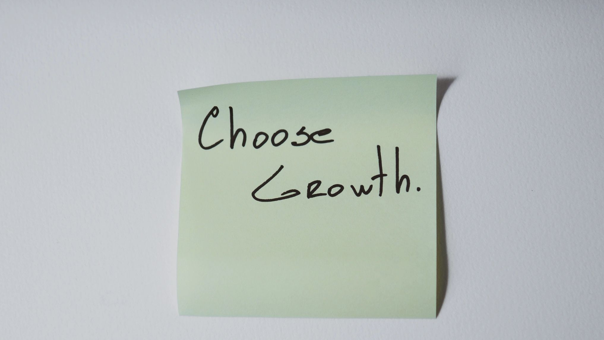 Sticky note with 'Choose Growth' written on it.