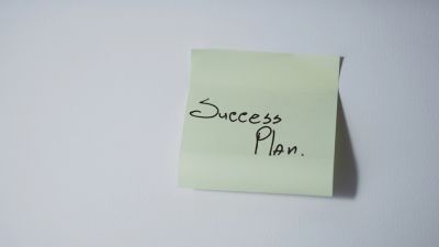 Sticky note with "Success Plan" written on it.