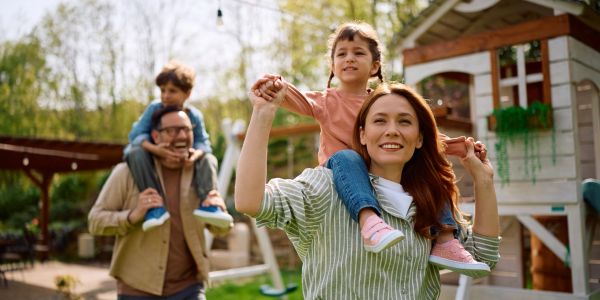 Family enjoying playful time outdoors.