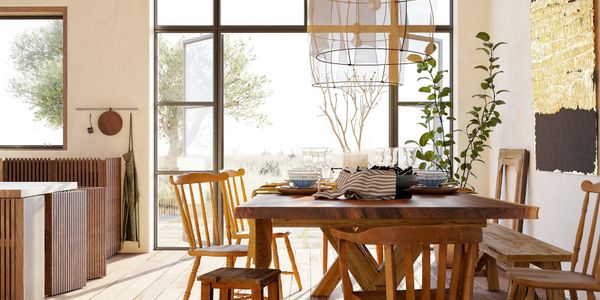 Cozy dining room with wooden furniture and large windows letting in natural light.