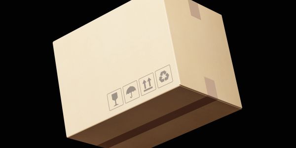 A cardboard box with handling symbols on a black background.