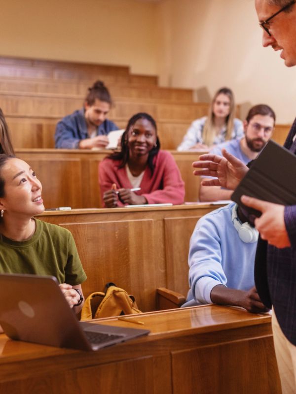 Professor talking to students in a lecture hall.