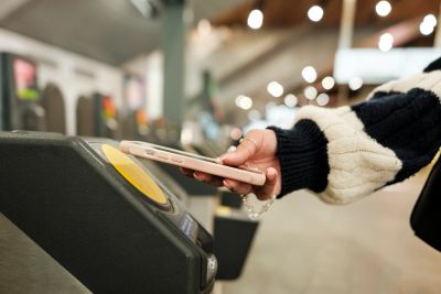 Person using a phone to access a card reader.