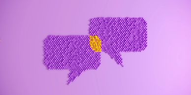 Two speech bubbles made of purple pills with a connecting area of yellow pills.