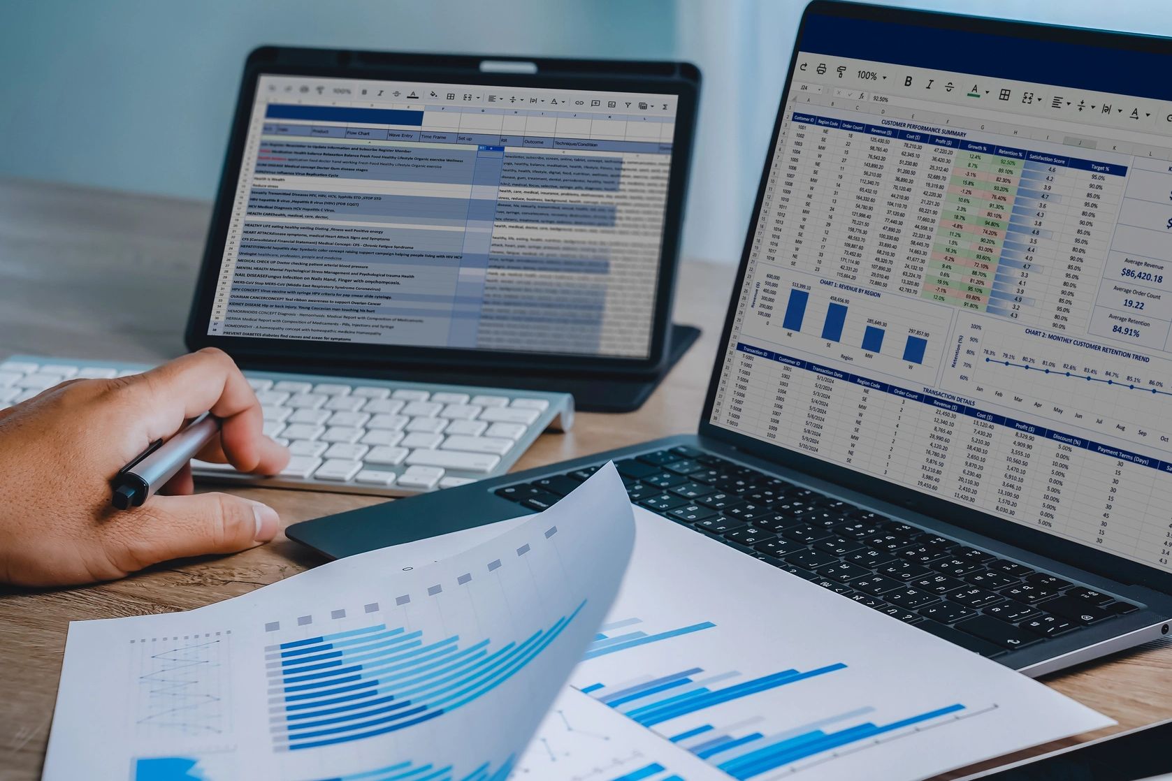 Two laptops displaying spreadsheet data