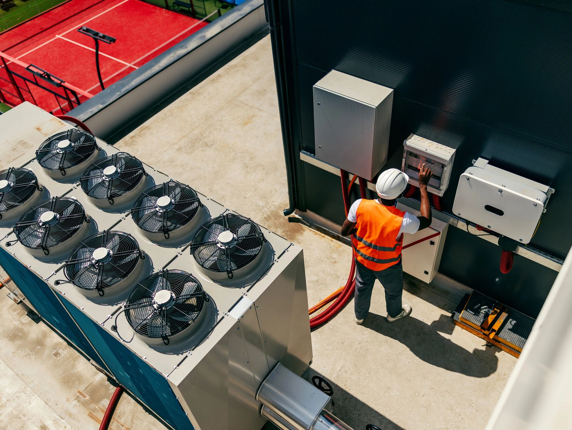Technician servicing commercial HVAC equipment on a Calgary rooftop - YYC Heating & Cooling Pros