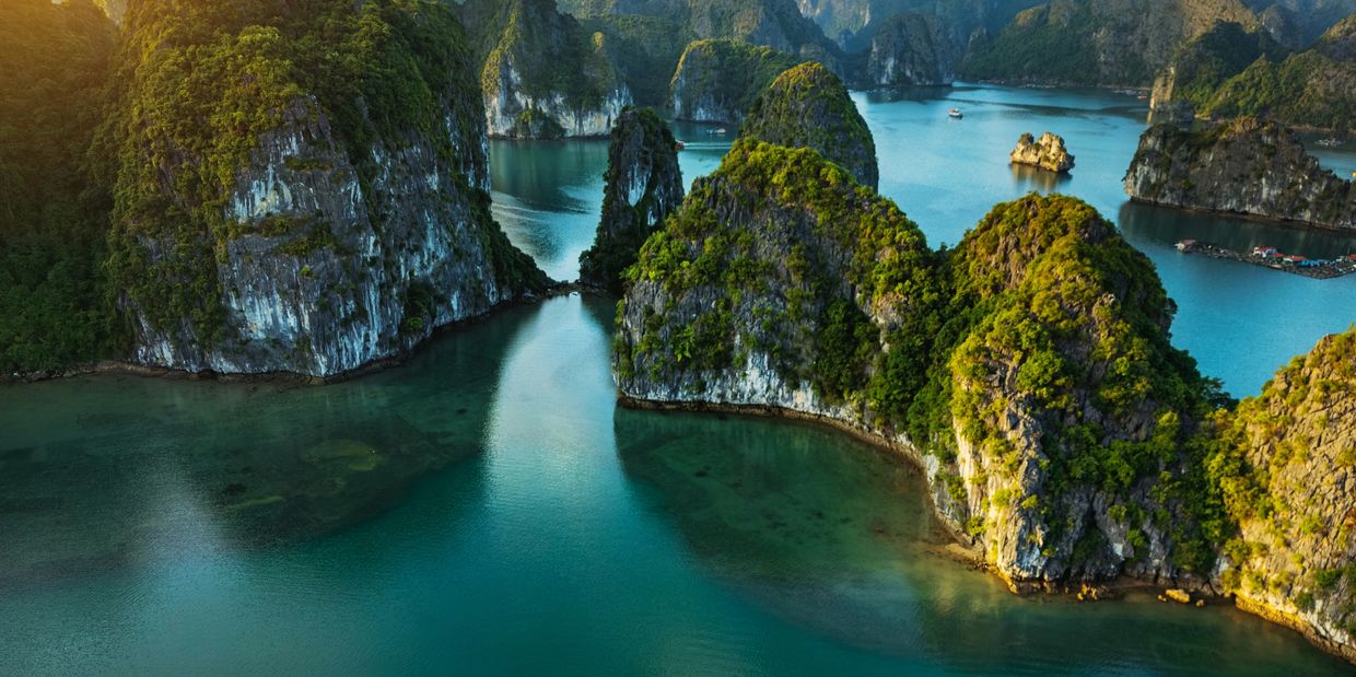 Scenic view of emerald water and limestone islands.