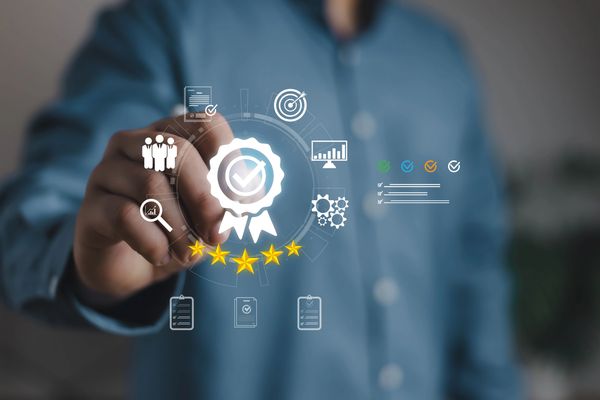 Hand interacting with digital quality and rating icons, highlighting a five-star rating.