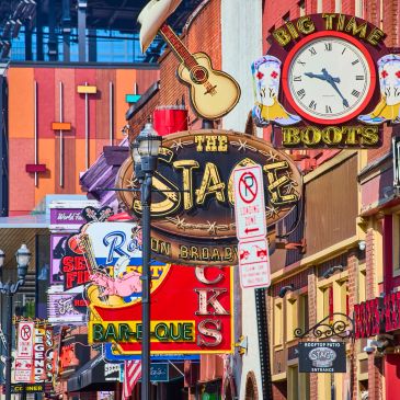 Colorful neon signs and marquees on a bustling street.
