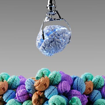 A robotic claw picks up a blue brain from a pile of colorful brains.