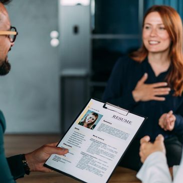 Person holding a resume during an interview.