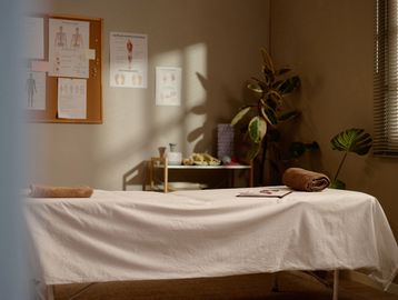 Calm massage therapy room with a treatment table.