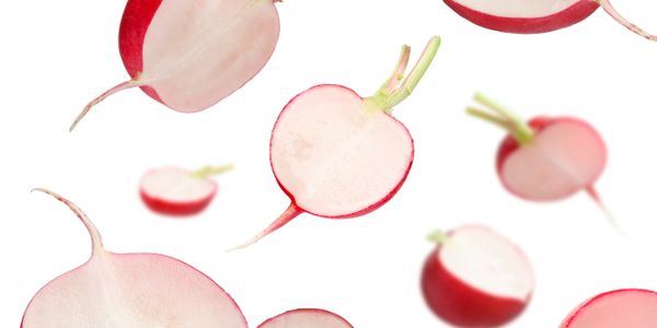 Sliced radishes floating against a white background.