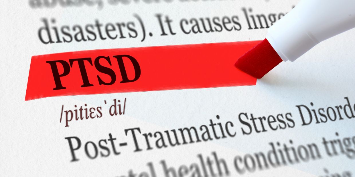 PTSD highlighted in red marker on a dictionary page.