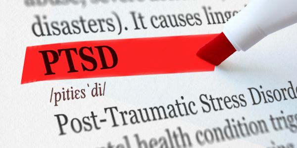 PTSD highlighted with a red marker in a textbook.