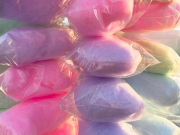 Bags of colorful cotton candy stacked together.