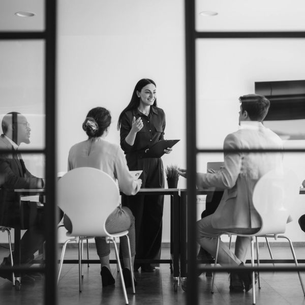 Woman leading a business meeting with four colleagues.