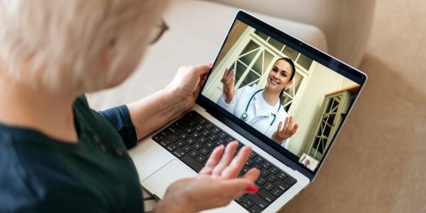 Woman having a video call with a doctor on a laptop.