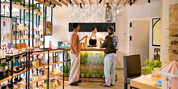 Customers interacting with a cashier in a modern store.