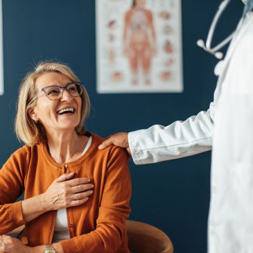 Happy senior woman with doctor.