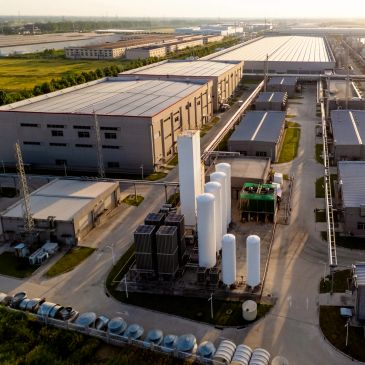 Aerial view of an industrial factory complex with large storage tanks.