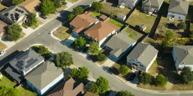 Aerial view of a suburban neighborhood with houses and trees.