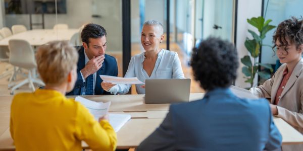Business team engaged in a meeting, discussing documents.