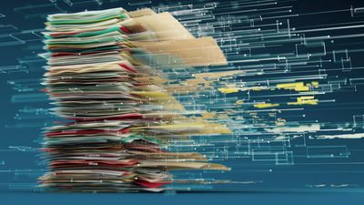 Image: stack of papers and files seemingly being wisked away.