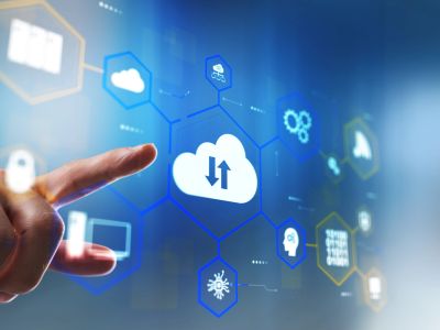 Finger pointing at cloud computing icons on transparent screen.