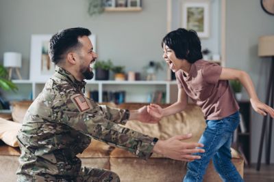Soldier reunites joyfully with child at home.