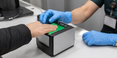 Person's hand being scanned on a biometric device.