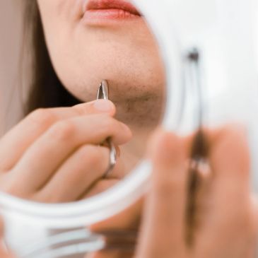 woman plucking chin hair