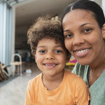 Smiling mother and son close-up indoor portrait.