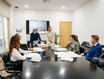 Business meeting with six professionals around a table.