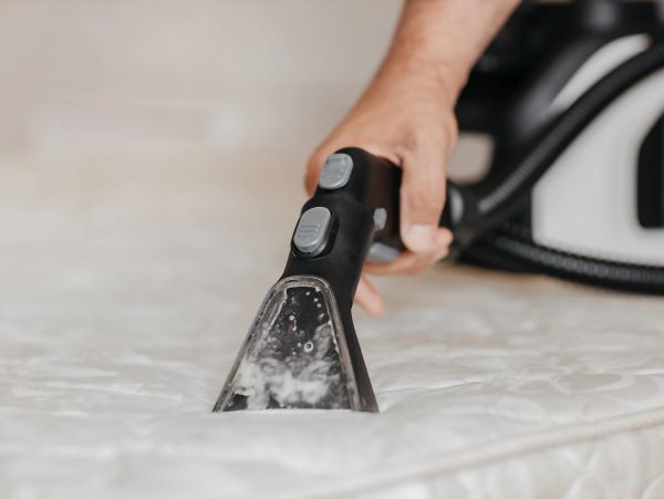 Hand cleaning mattress with steam cleaner.