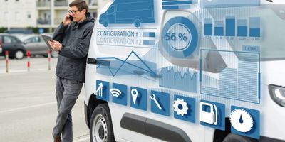 Man using phone beside van with digital tech graphics overlay.