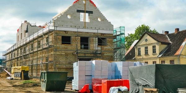 Building under construction with scaffolding and materials.