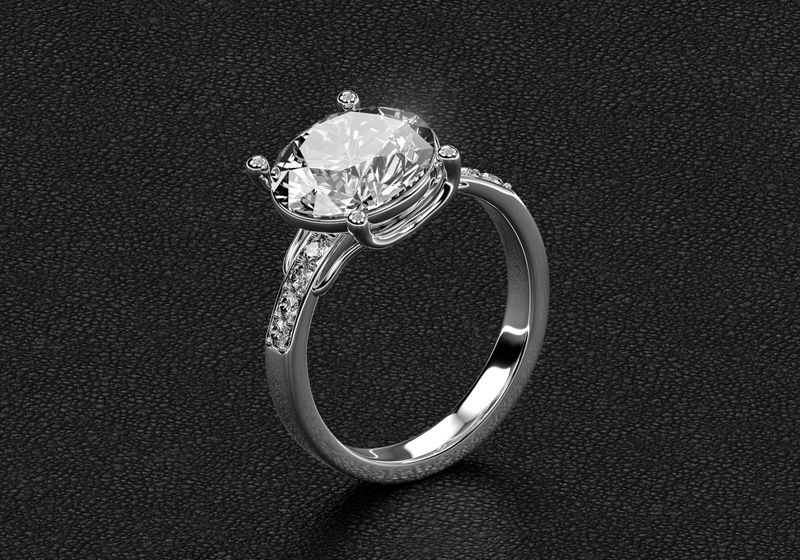 Luxury diamond engagement ring in white gold or platinum on black leather background