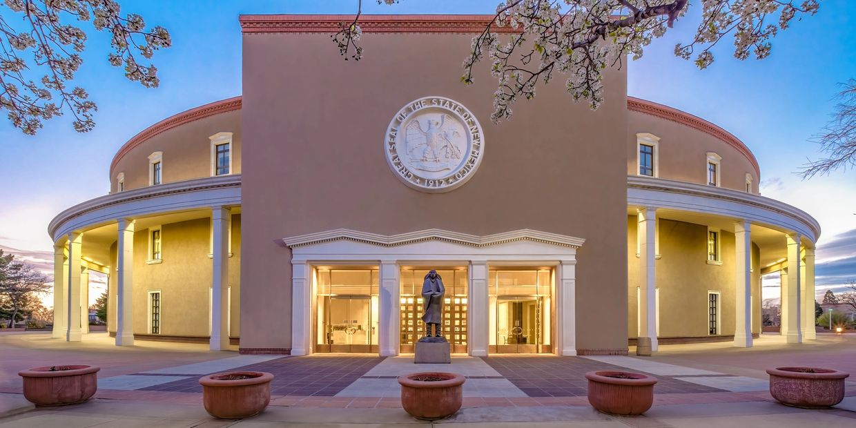 New Mexico State Capitol building at dusk.