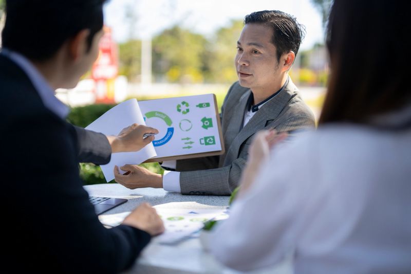 Business team exploring environmental, social, governance strategies during an outdoor meeting