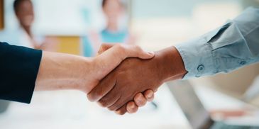 Two people shaking hands in agreement.