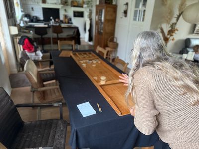 Woman playing a tabletop game indoors.