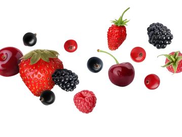 Assortment of fresh berries and a cherry on white background.